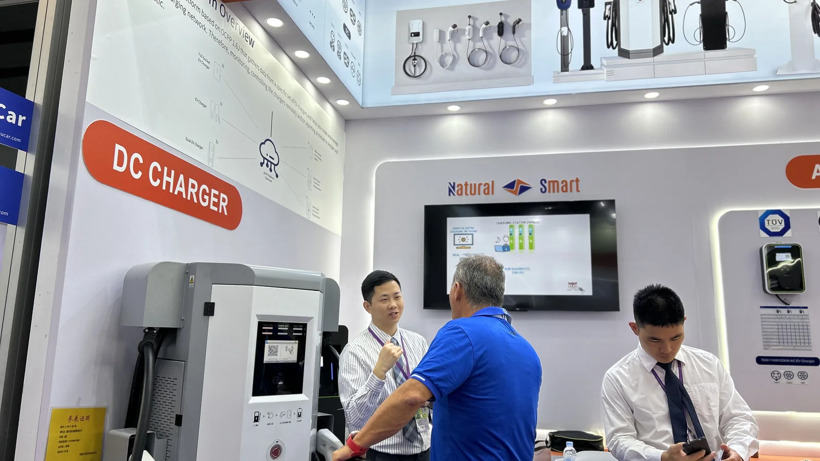 Natural Smart DC fast charger booth demonstration with an international exhibition visitor